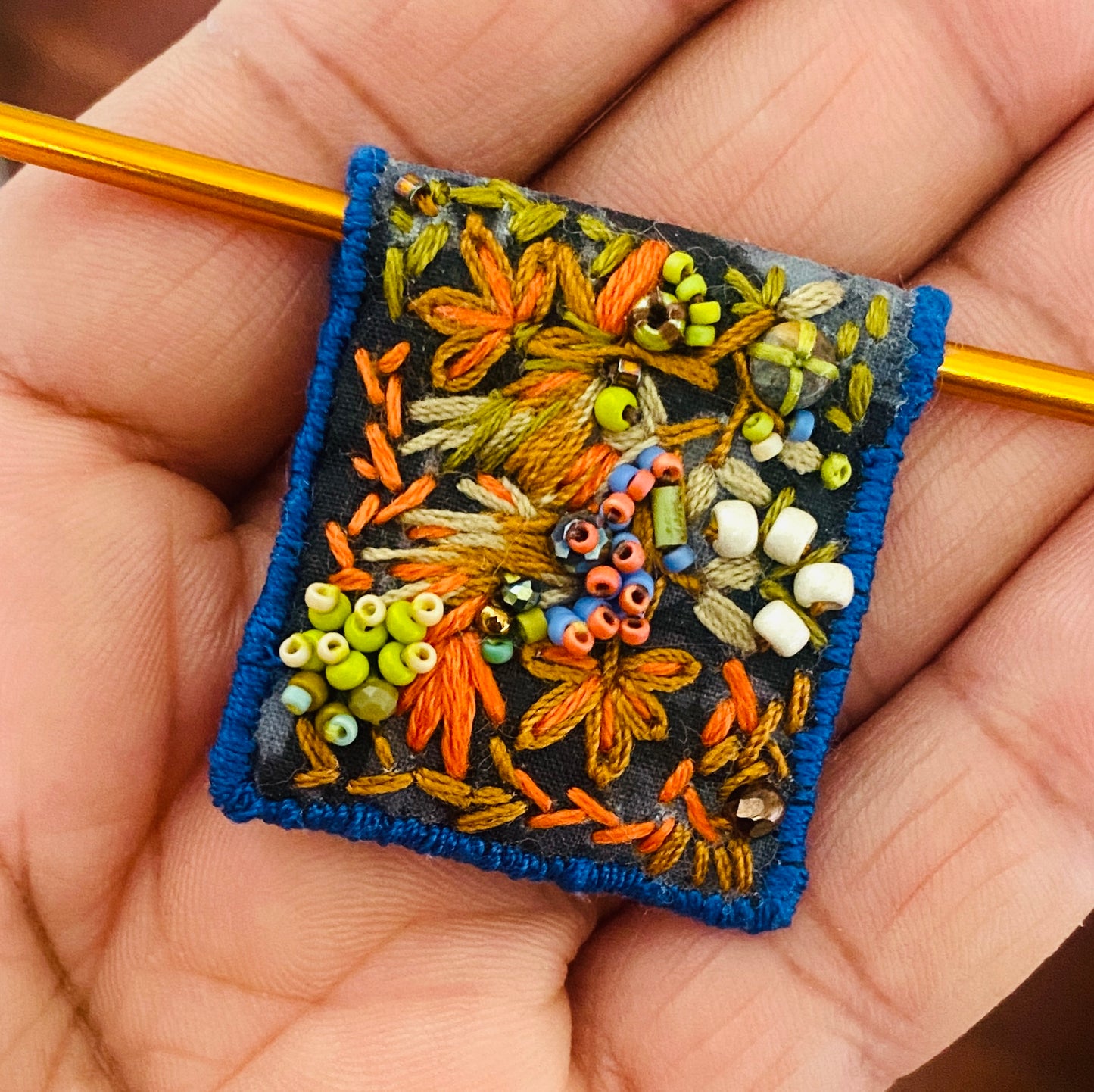 "Garden delight" Green, orange, tan embroidered, beaded textile necklace.