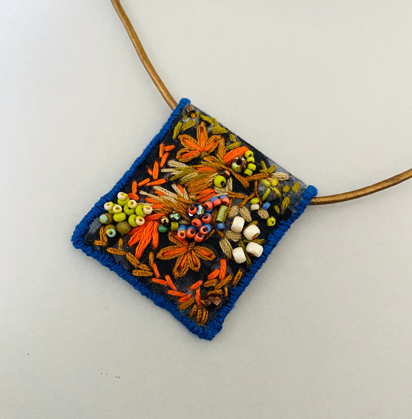 "Garden delight" Green, orange, tan embroidered, beaded textile necklace.