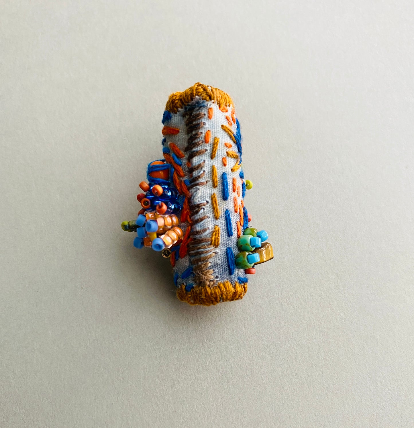 "Horizon" Blue and orange embroidered and beaded textile necklace.